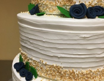 Buttercream Covered Cake with Gum Paste Flowers Wedding Cake with Navy Blue Flowers at Nichole's Fine Pastry, Fargo, ND